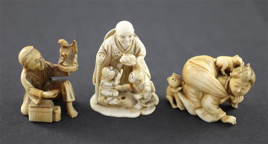 A Japanese ivory netsuke and two similar okimono